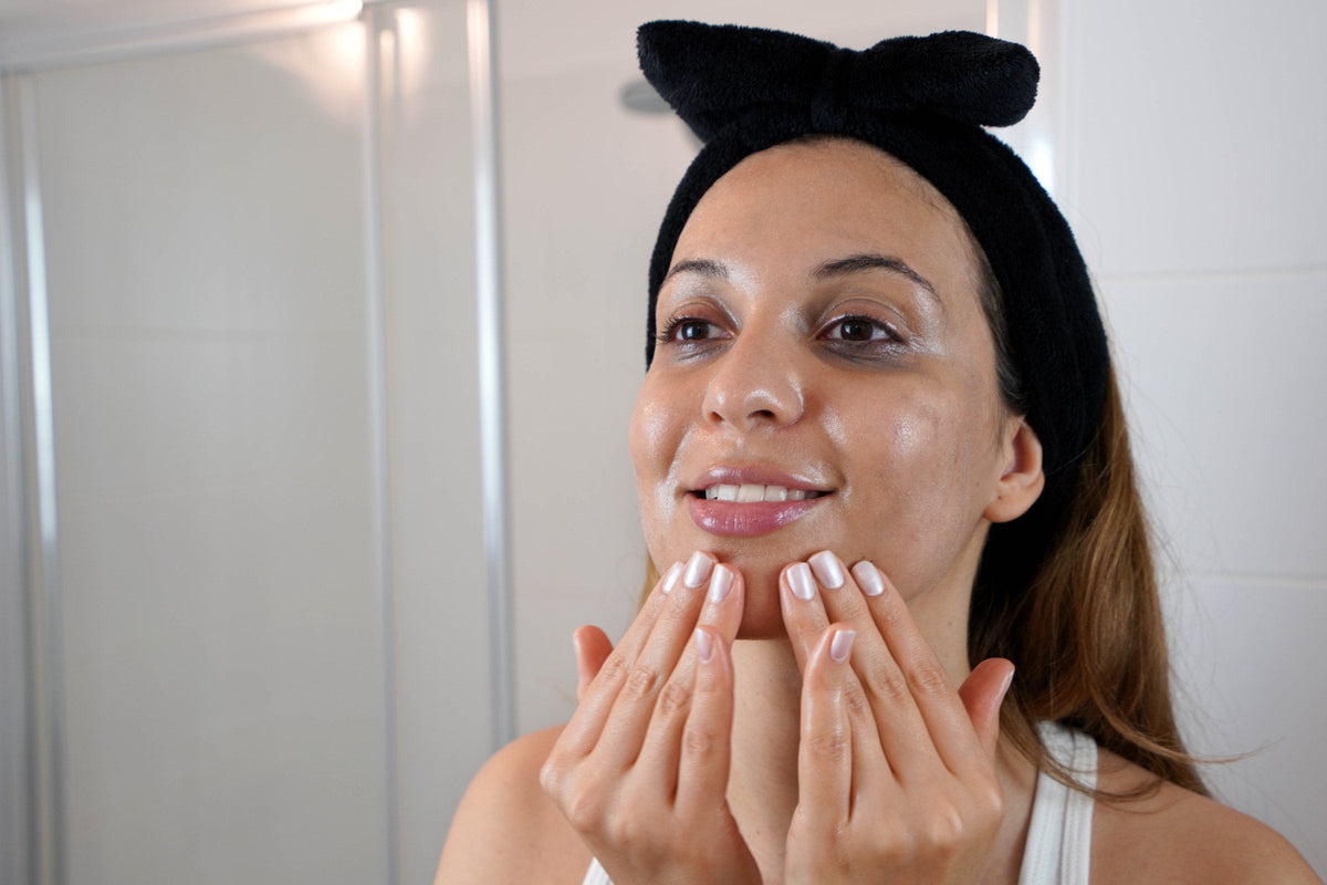 A woman massaging cleansing oil into her face