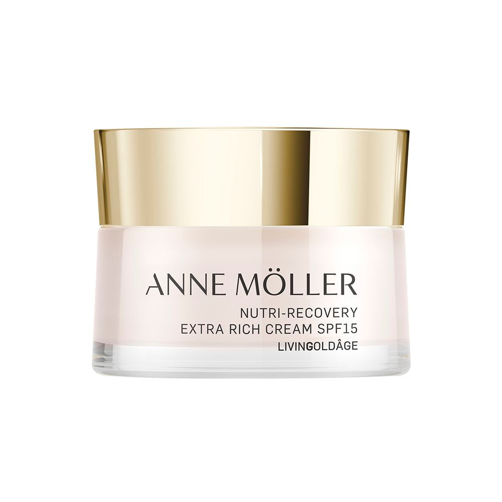 Anne Möller Light pink plastic cream jar with golden lid, minimalist label reading SPF 15, photographed close-up