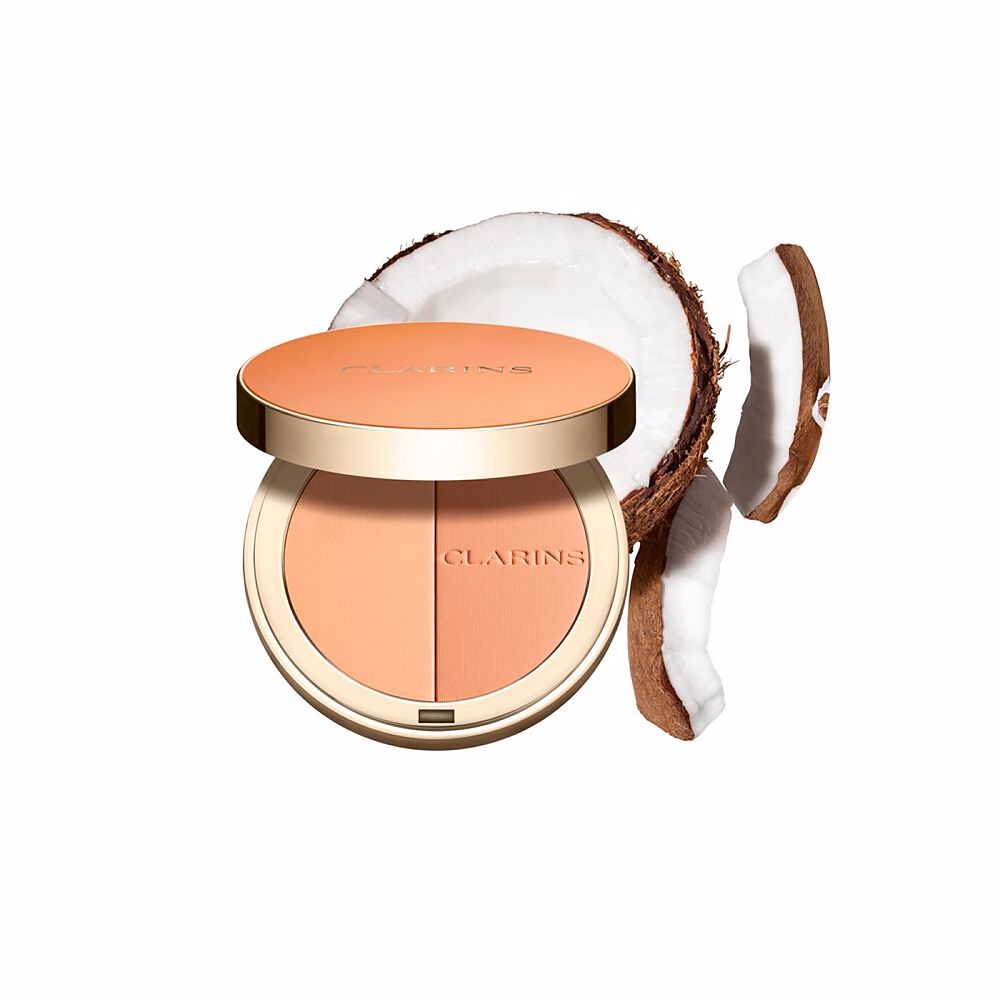 Clarins Round orange compact powder case with metallic rim, embossed brand name, minimalist metal/plastic finish