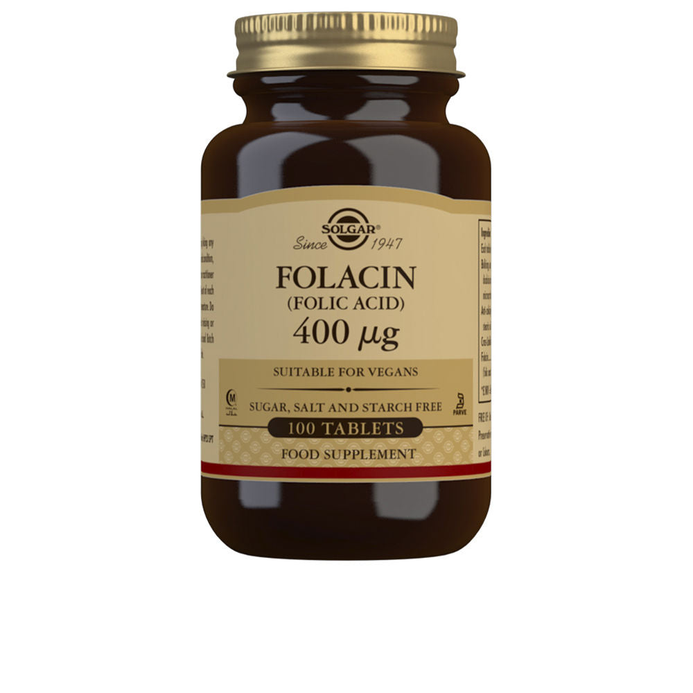 Bottle of 100 folic acid 400 µg tablets, tablet close-up