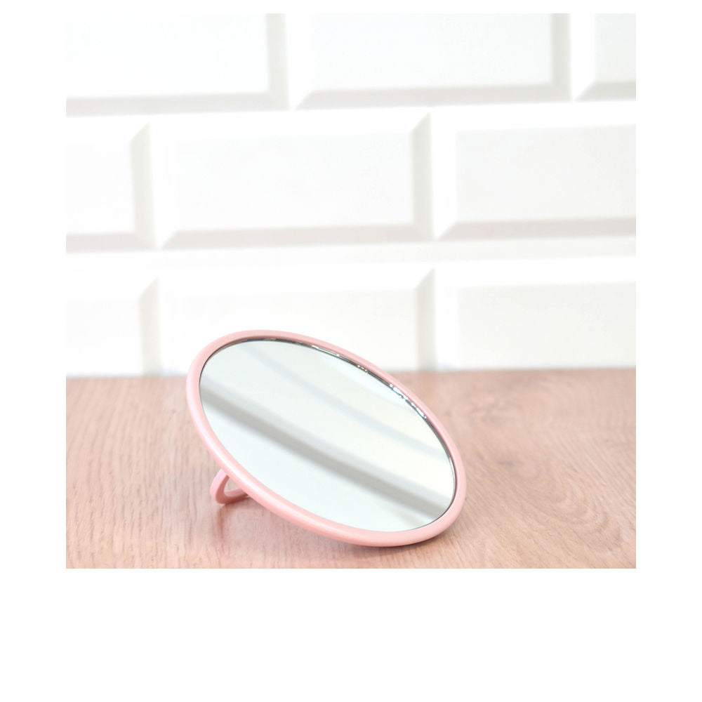 Pink round tabletop magnifying mirror with metal frame and stand support, minimalist craftsmanship Beter
