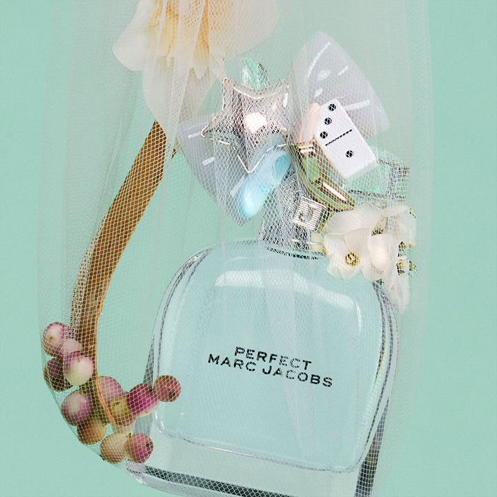 Faceted clear 50 ml eau de toilette bottle with silver cap and small bow