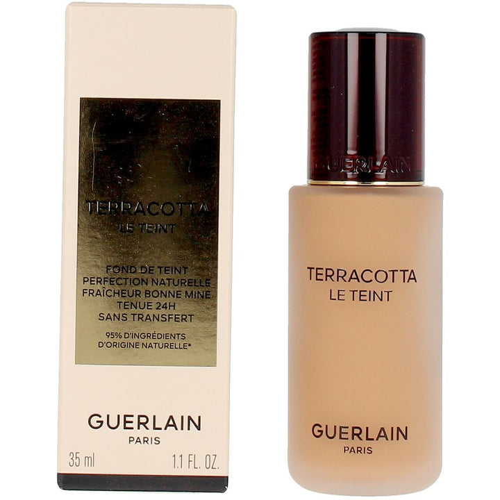 Frosted glass foundation bottle with dark brown embossed cap and gold-label rectangular box, Guerlain