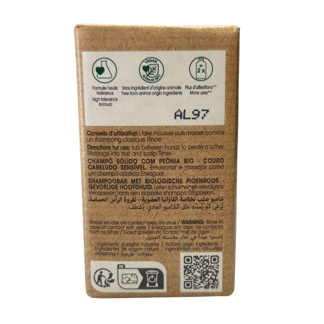 Klorane Brown rectangular shampoo bar in kraft paper with pink peony illustration, green accents, text labels, organic mark