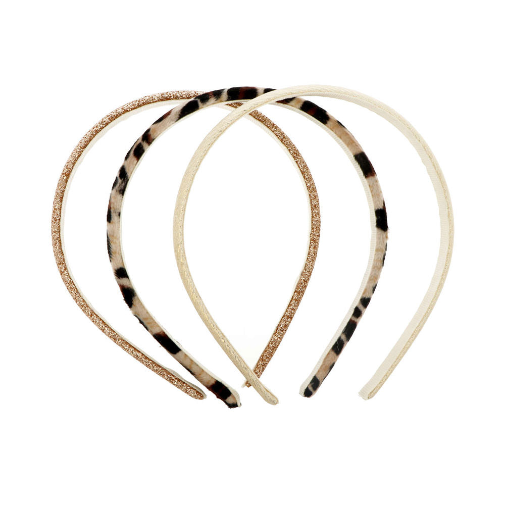 Three slim fabric-covered INCA headbands in coordinating patterns for babies and toddlers
