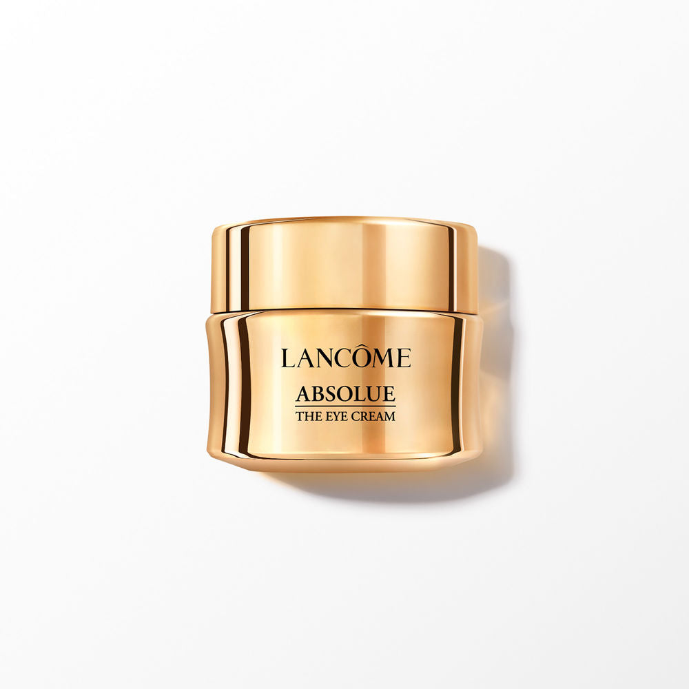 Gold metallic compact jar eye cream with reflective surface and open lid, sleek luxury design by Lancôme
