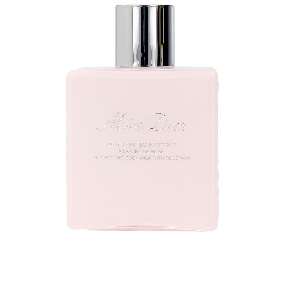 Miss Dior Moisturizing Body Milk bottle beside soft rose petals