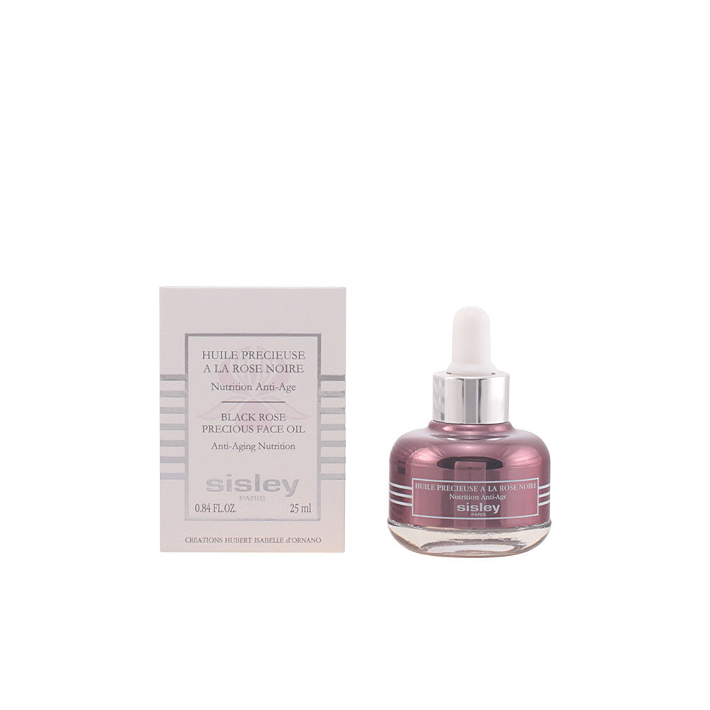 Sisley Pink and silver round glass face oil bottle with dropper cap and labeled box