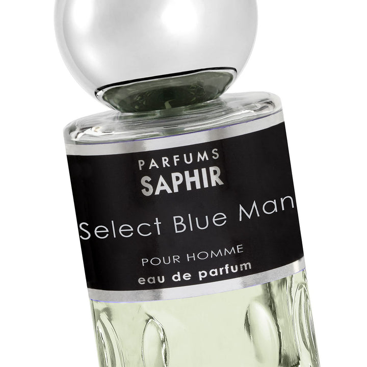 Parfums Saphir Glass eau de parfum bottle with raised circular texture, clear liquid, black label, silver cap