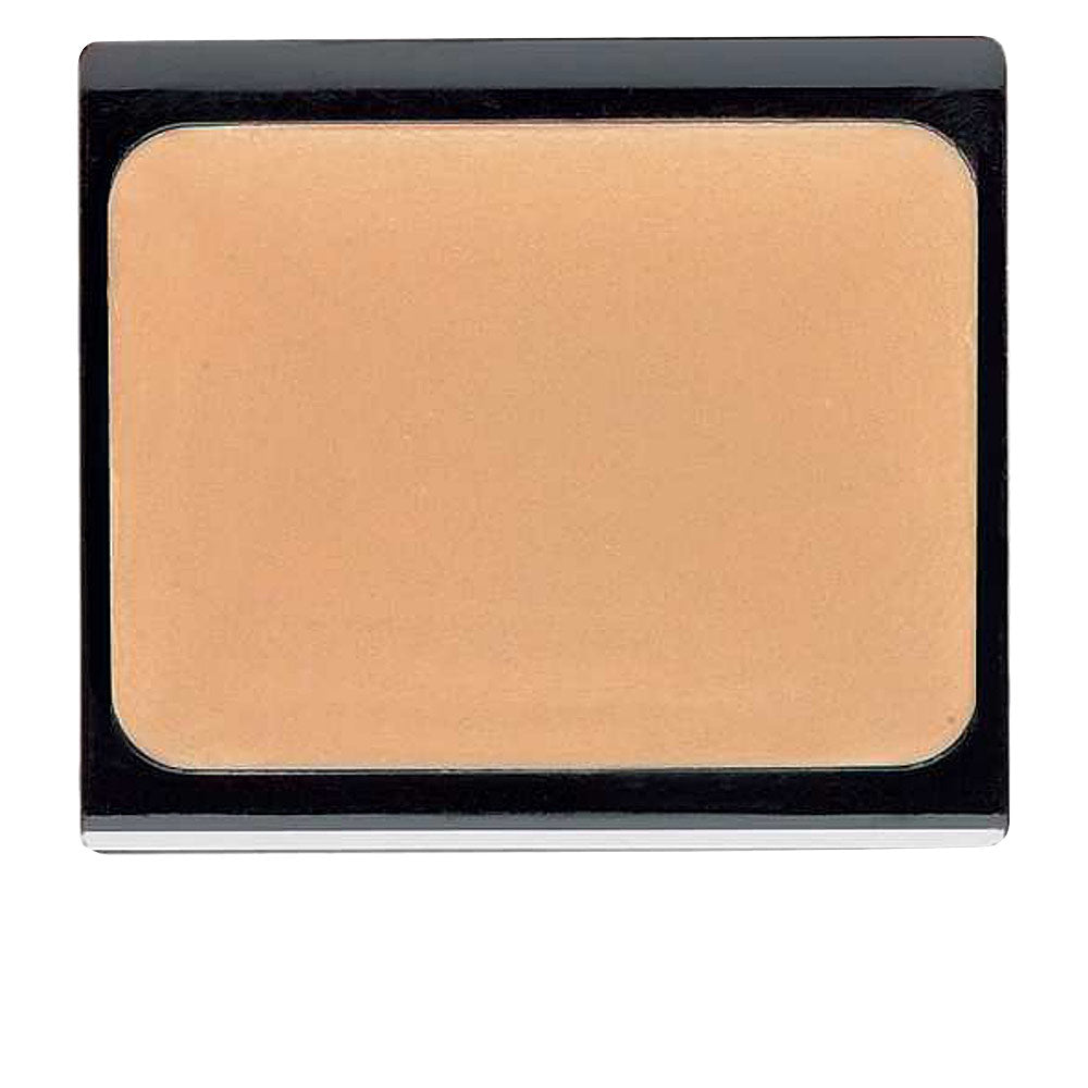 Small 4.5 g compact cream concealer in beige‑apricot shade, sleek pot packaging