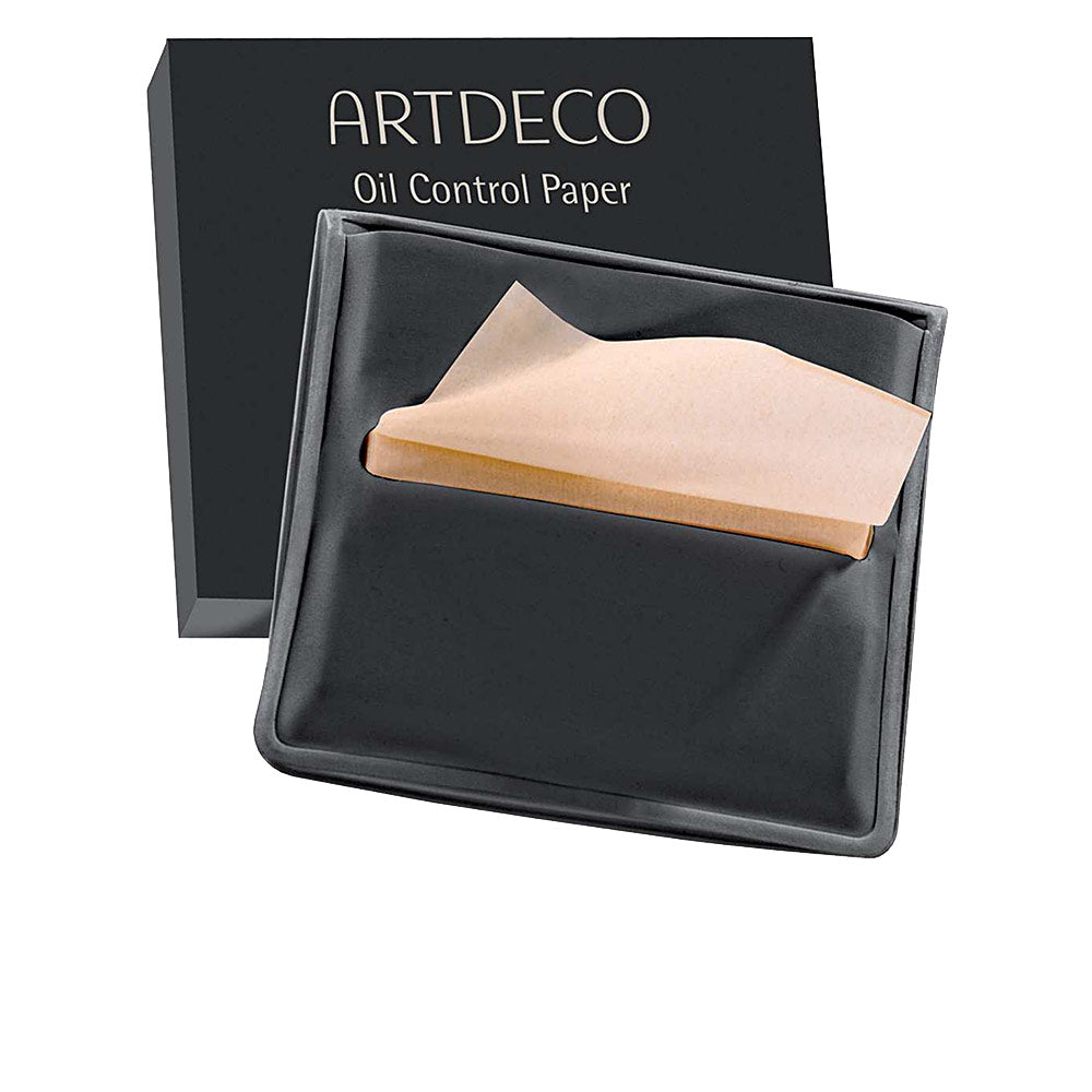 Black tray holding rectangular beige paper blotting sheets with a folded top sheet, refined paper texture, Artdeco