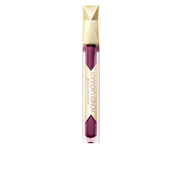 Max Factor Modern plastic lip gloss tube with transparent body, visible purple liquid, geometric gold cap, vertical label