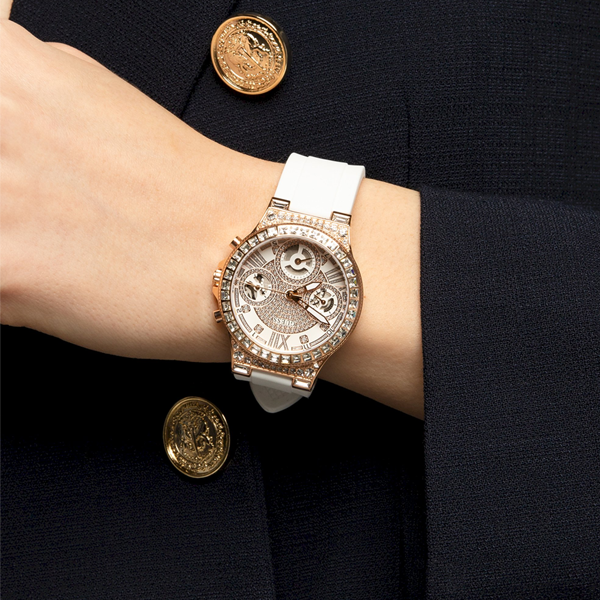 Rose gold chronograph wristwatch on white dial, crystal accents, silicone strap, luxury finish