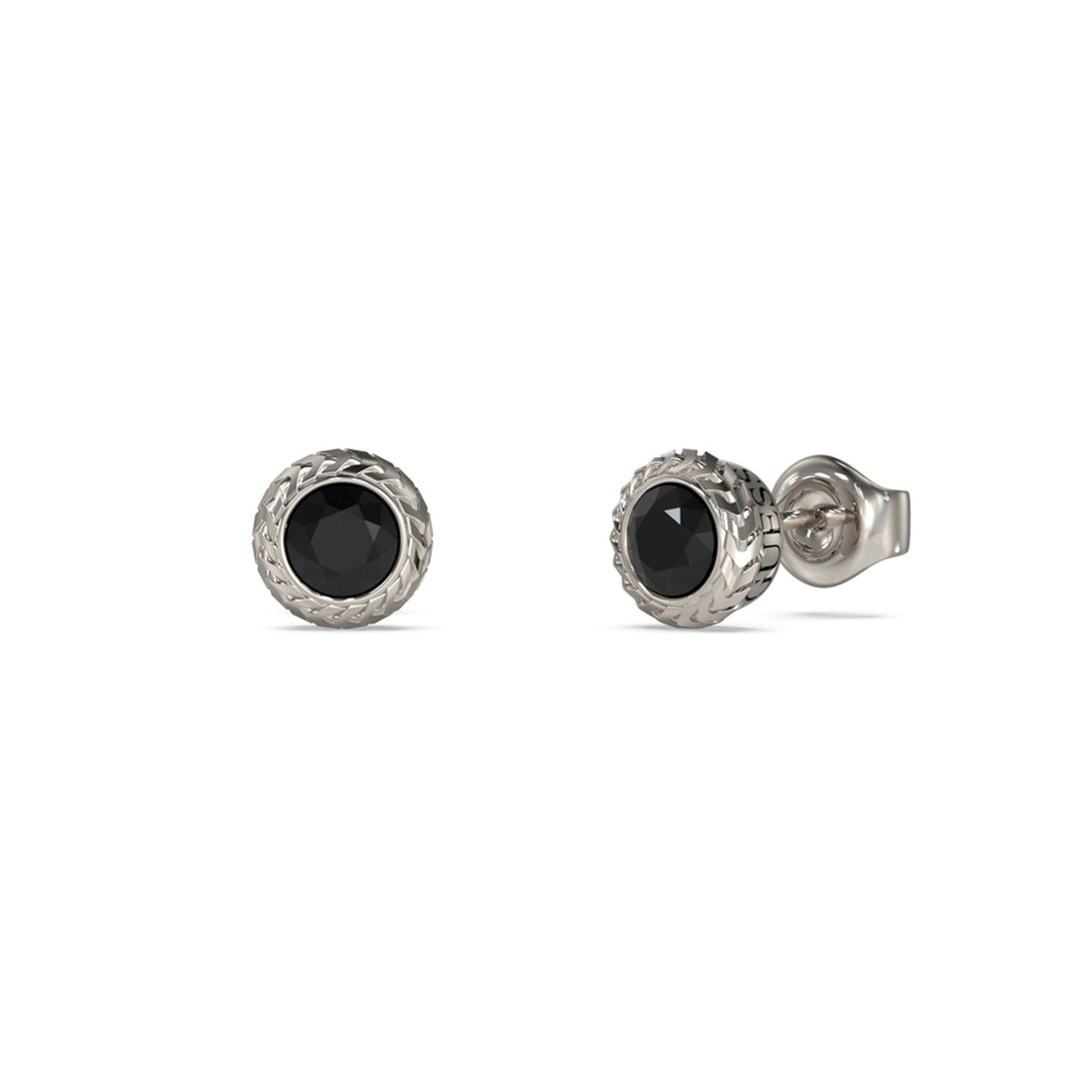 Close-up of silver stud earrings with faceted black stones and textured silver borders on white background