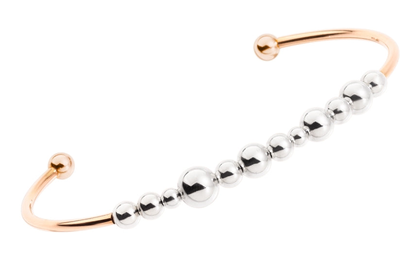 Rose gold open cuff bracelet with graduated silver beaded detailing and polished finish on wrist